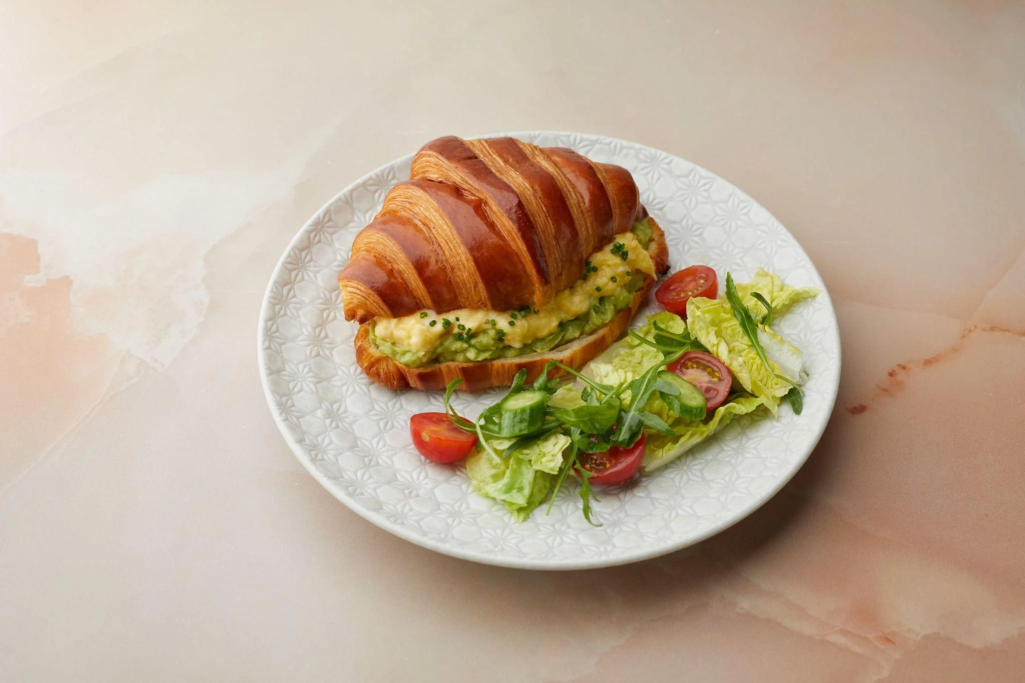  A croissant on a white plate  
