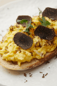 Scrambled eggs toast with dried meat on top