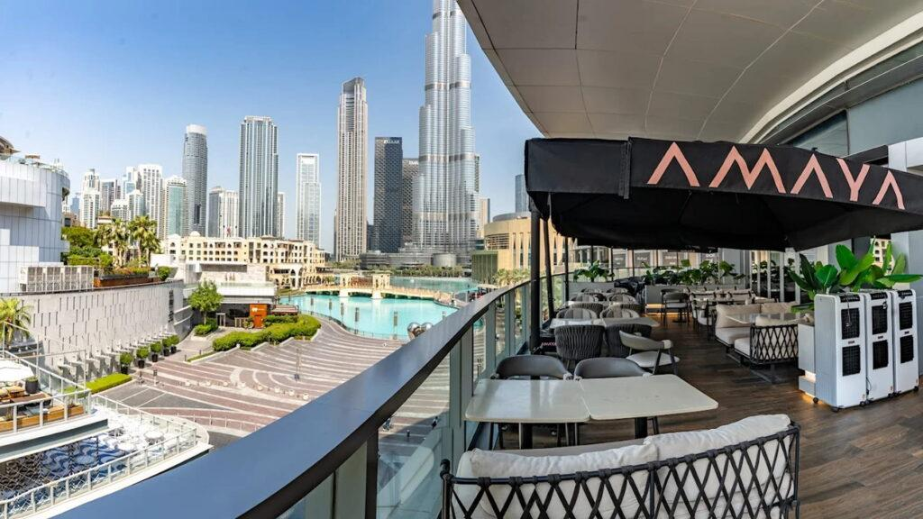 The outdoor seating area of Amaya with fountain views