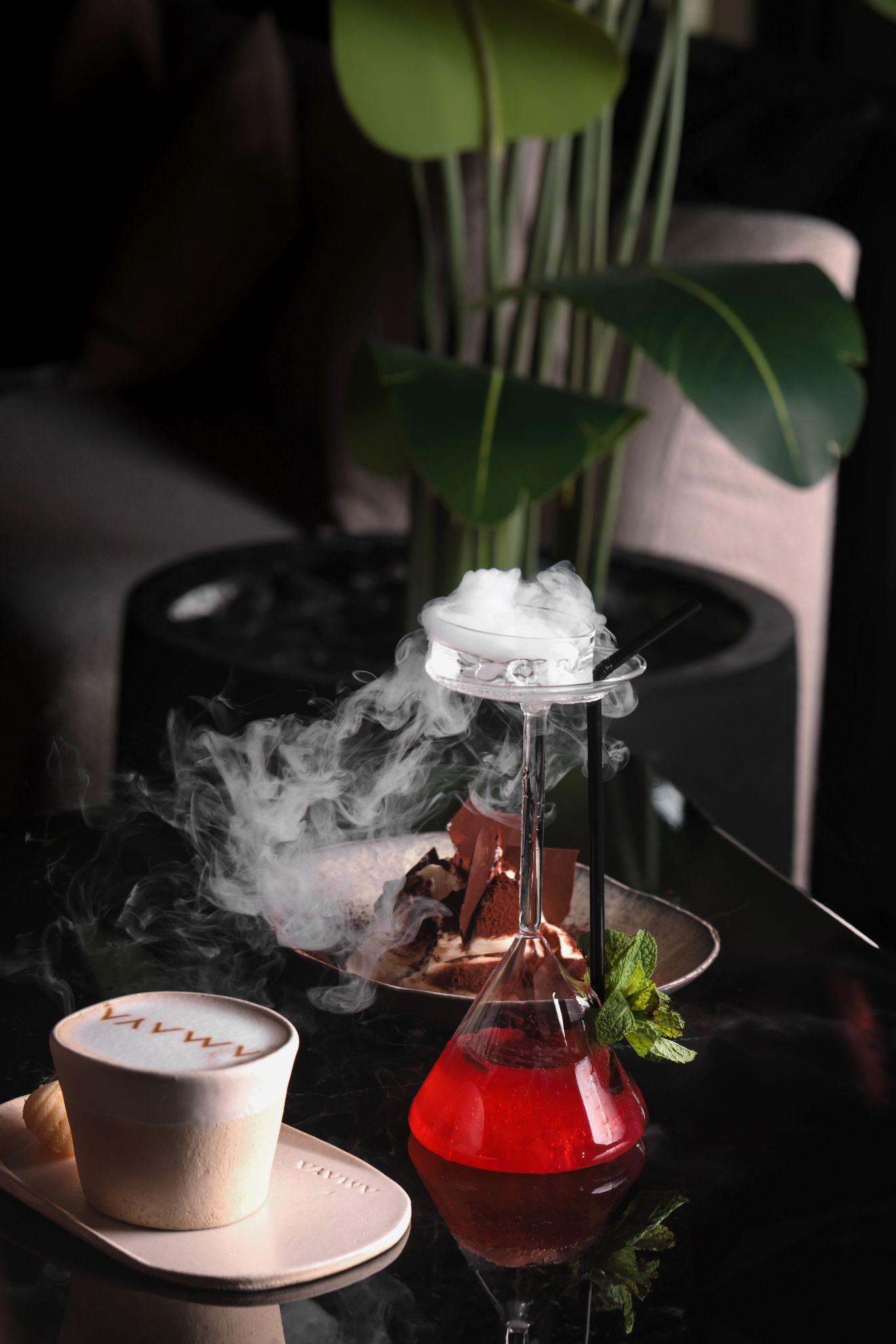 Two drinks on the table with a green plant in the background