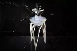 A silver shisha on a black floor