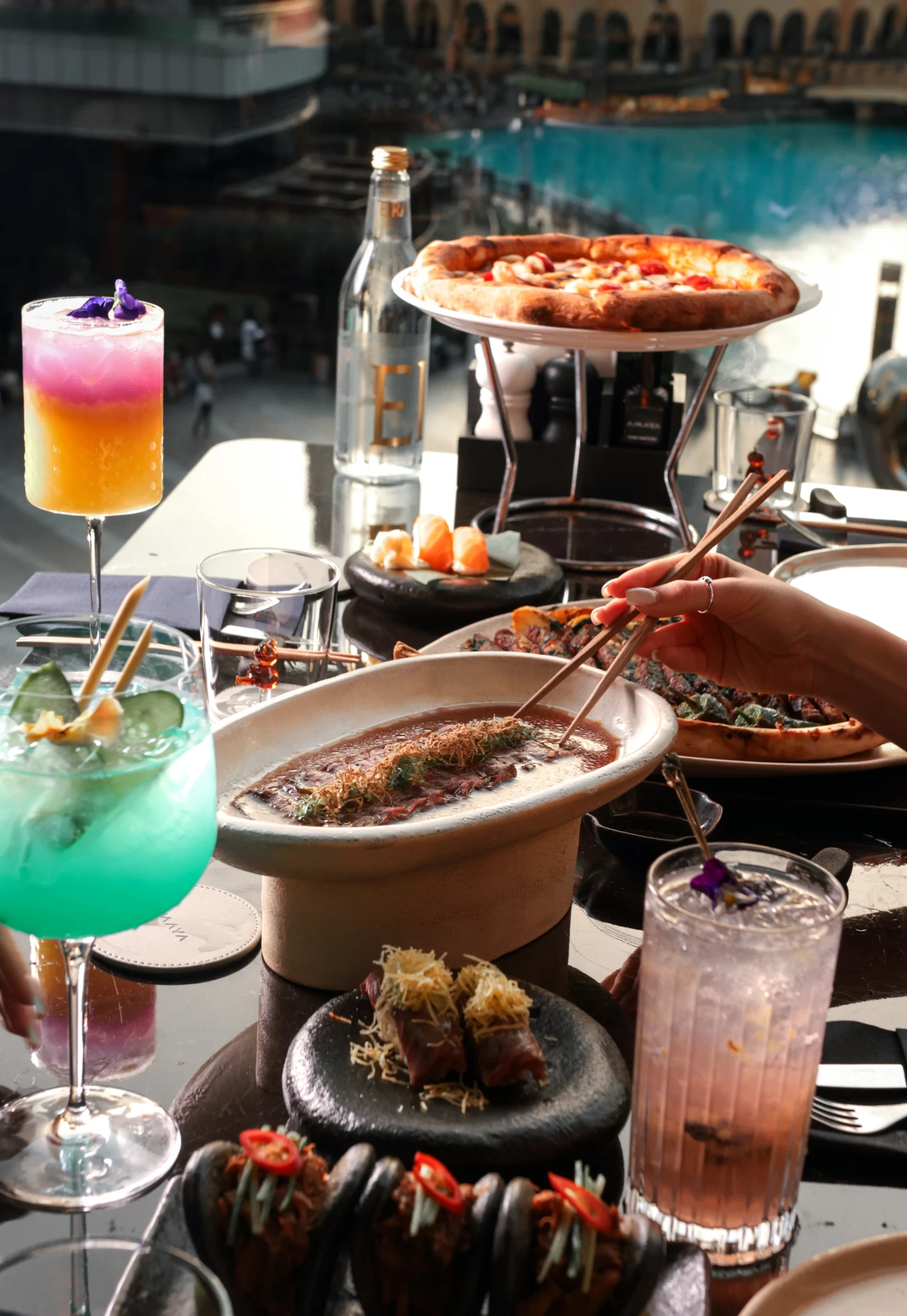 Amaya food on the table with fountain view in the background