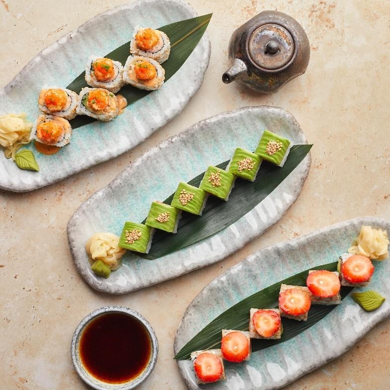 Three plates of Japanese food with sauces and garnishes