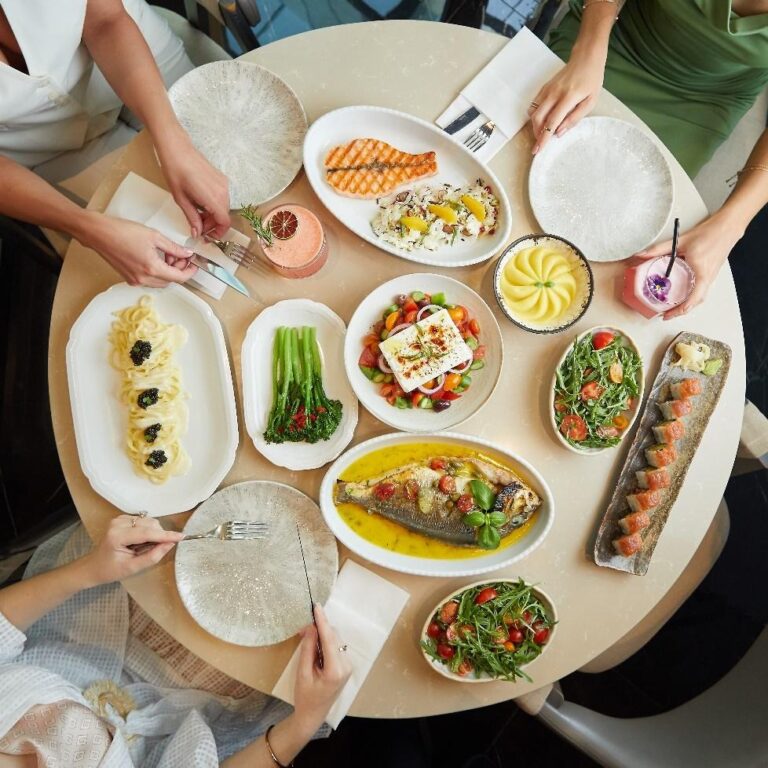 A table full of healthy food options with plates and cutlery