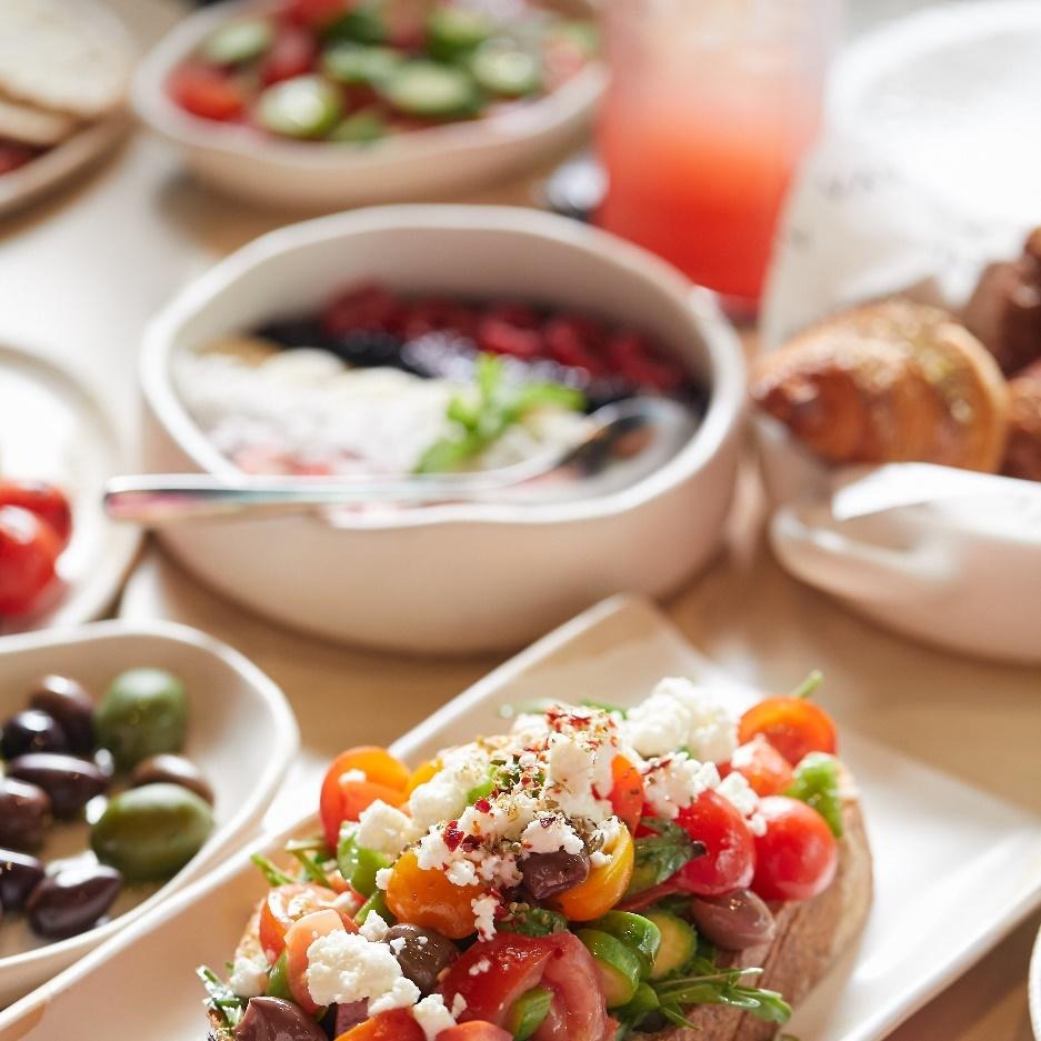 Food on the platter with herbs, cheese, garnishes, and spices